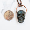 Labradorite skull pendant shown beside Canadian Quarter coin.