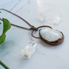 The angle shows the texture detailing on this large Rainbow Moonstone and Copper electroformed necklace.