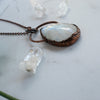 The angle shows the texture detailing on this large Rainbow Moonstone and Copper electroformed necklace.