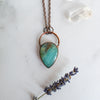 Peruvian Blue and Copper necklace arranged beside a quartz crystal and lavender sprig.