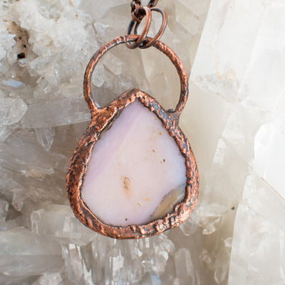 The back view of the Pink Australian Opal and copper pendant showing copper detailing against a Quartz background.