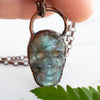 Light shining through the Labradorite and Copper skull pendant.