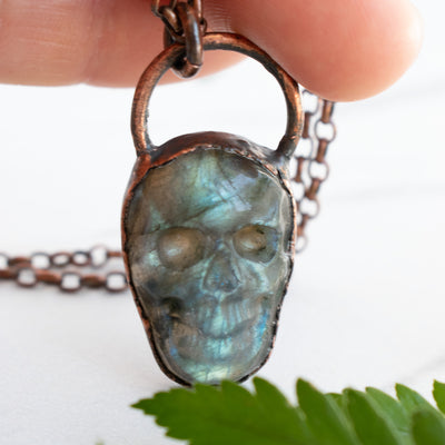 Light shining through the Labradorite and Copper skull pendant.