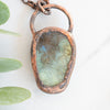 Backside of the Labradorite and copper pendant showing the flashes of labradorescence on of the back of the stone.