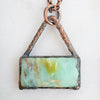 Blue green and brown swirls in a rectangular Blue Opal and Copper pendant.