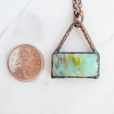 Peruvian Blue Opal and Copper pendant shown beside a Canadian Quarter coin.