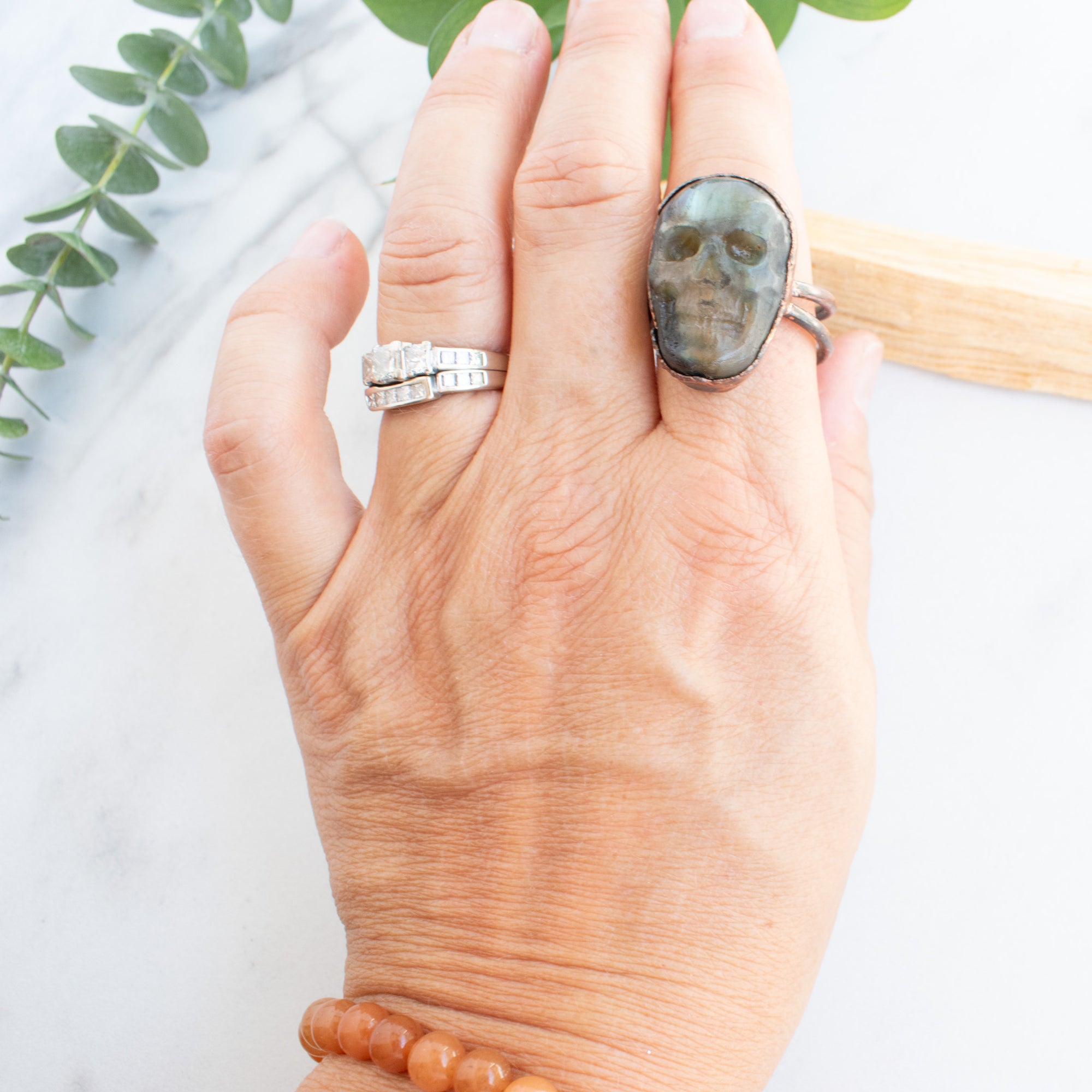 Copper and Labradorite Skull ring shown worn on a hand.