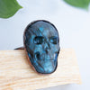 Blue Labradorite and Copper Skull ring on a piece of Palo Santo.