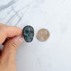 Labradorite and Copper Electroformed Skull Ring beside a Canadian Quarter coin.