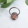 Backview of a Peach Moonstone and Copper Ring showing the detail and patina of the metal.