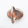 Close up of the back view of a Peach Moonstone and Copper Ring showing the detail and patina of the metal.