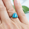 Blue Apatite and Copper ring worn on a woman's hand.