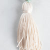 Handtied cream Silk tassel arranged on a white background.