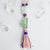Beautiful tones of purple, green and clear Rainbow Flourite accent the light pink and purple handmade tassel in this Mala necklace.