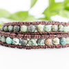 Close up photo shows the details of the African Turquoise beads in this leather wrap bracelet.