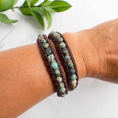 Leather and African Turquoise wrap bracelet worn on a woman's wrist.