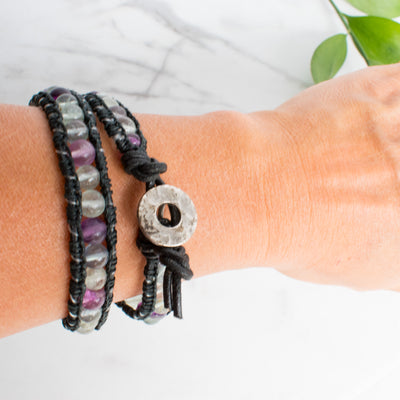 Fluorite and black leather wrap bracelet shown on a woman's wrist.