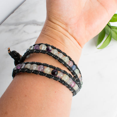 Fluorite and black leather wrap bracelet shown on a woman's wrist.