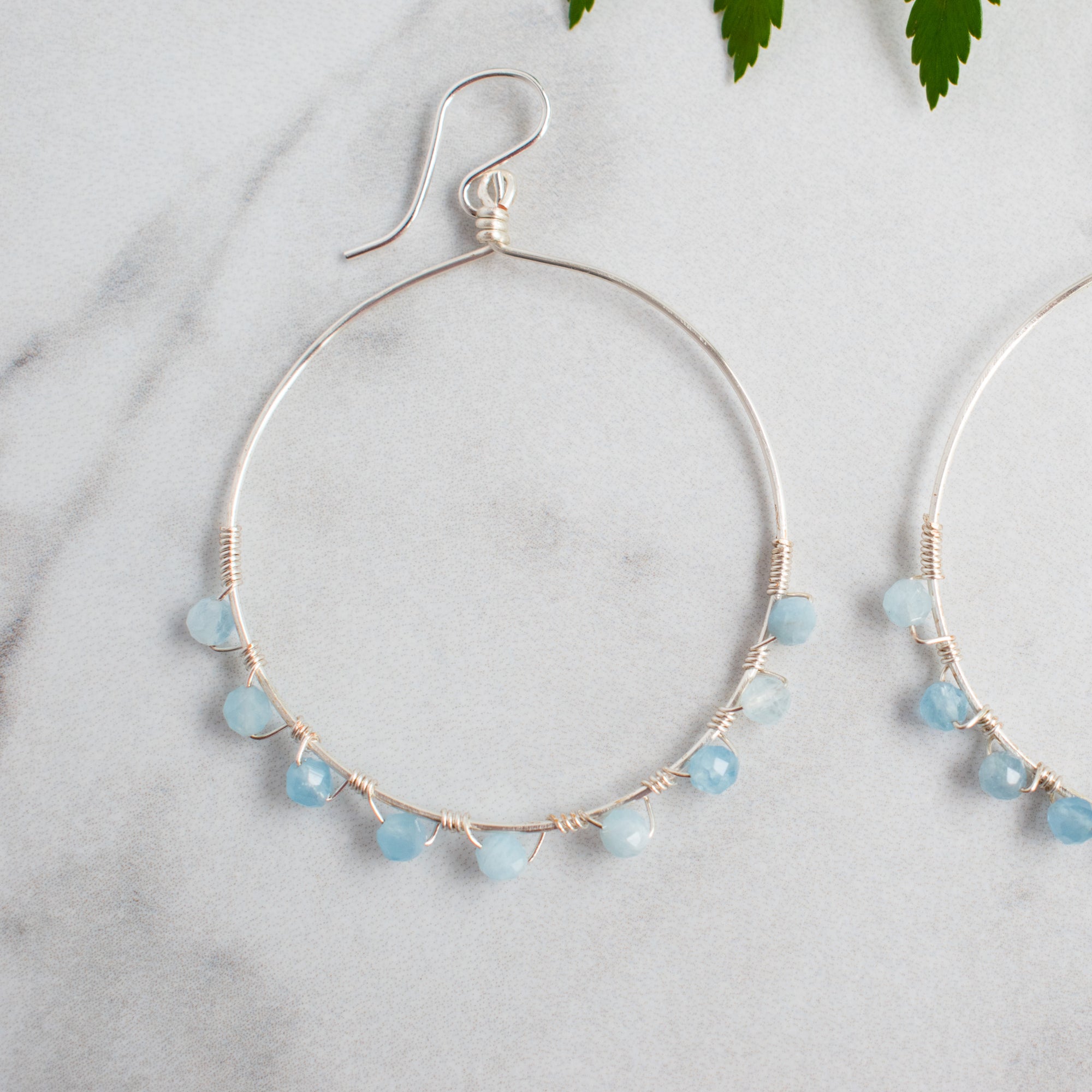Cool blue faceted Aquamarine and Silver plated hoop earrings.
