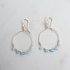 Icy blue Aquamarine and silver hoop earrings on a white background.