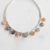 Peach and Grey tones of Moonstone faceted beads shine against the details of these silver plated hoop earrings.