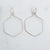 Delicate Silver plated wire wrapped hexagon earrings on a white background.