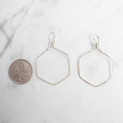 Silver plated wire wrapped hexagon earrings shown beside a Canadian Quarter for size reference.