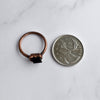 Black Tourmaline and copper ring shown beside a Quarter coin for size comparison.