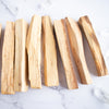 Palo Santo wooden sticks are arranged in a line.